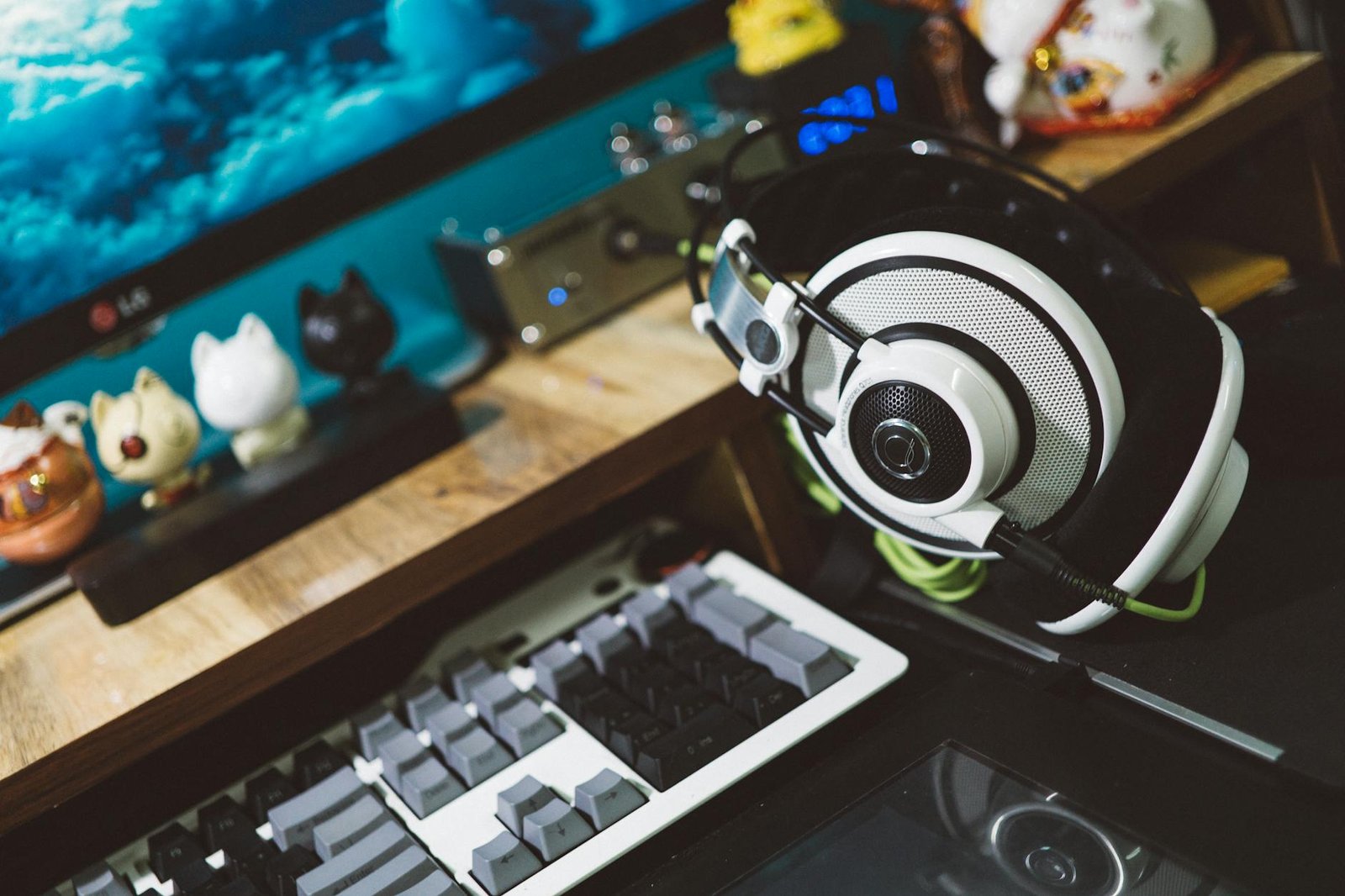 black and white headset next to white black and gray computer keyboard