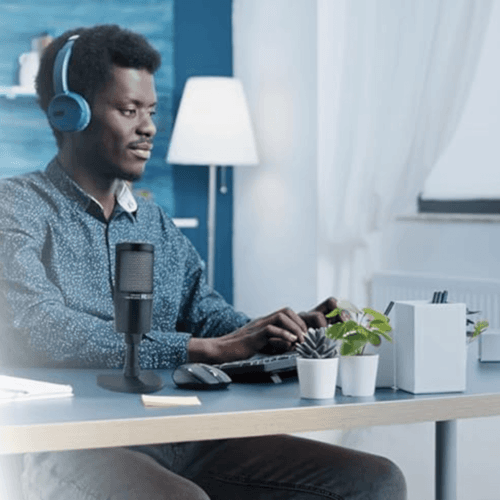 Creator speaking into Emerson RGB microphone with headphones